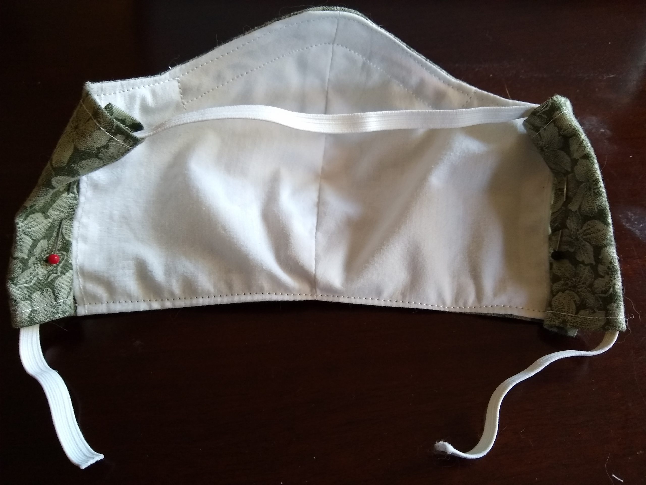 cloth mask with looped elastic behind the head